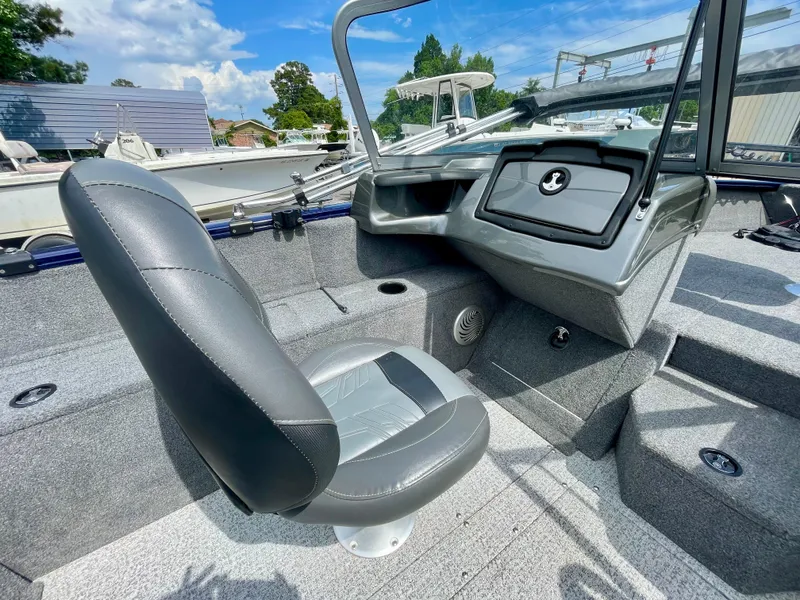 Slide: The Image of 2020 Tracker Pro Guide V-175 Combo boat interior with gray seating and dashboard. - 14