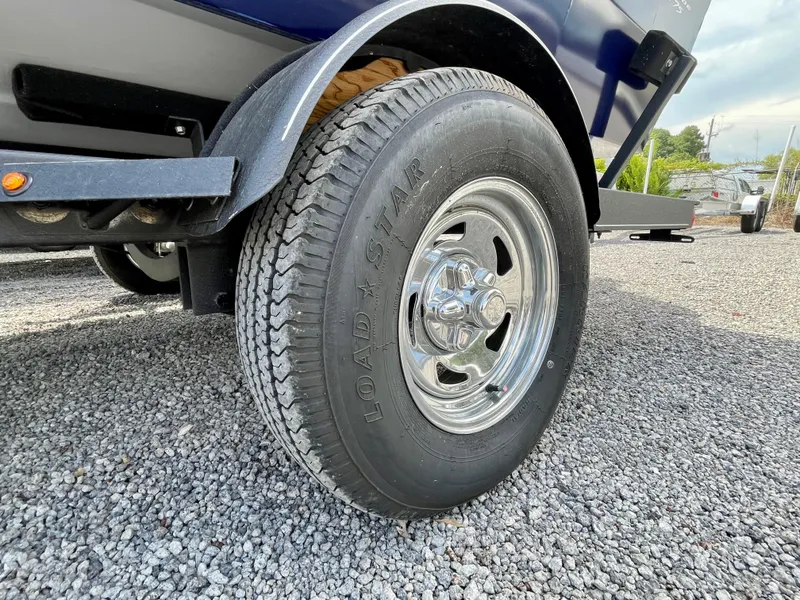 Slide: The Image of Trailer tire of 2020 Tracker Pro Guide V-175 Combo on gravel surface. - 18
