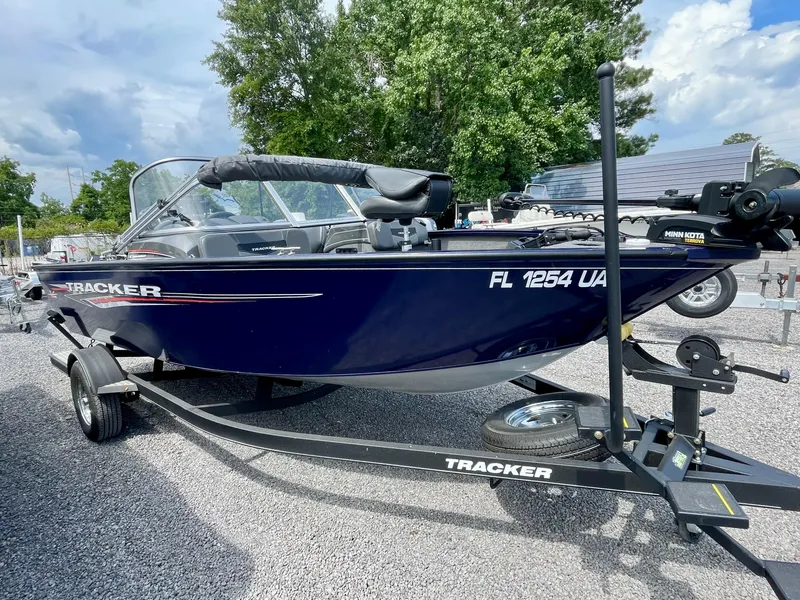 Slide: The Image of 2020 Tracker Pro Guide V-175 Combo boat on trailer, parked outdoors. - 4