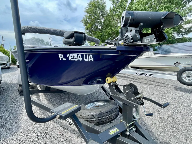 Slide: The Image of 2020 Tracker Pro Guide V-175 Combo boat on trailer, parked outdoors. - 6