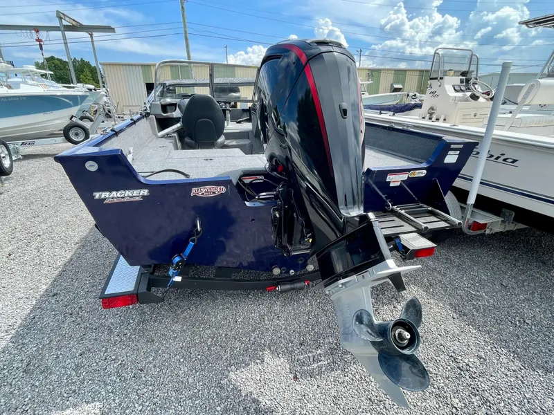 Slide: The Image of 2020 Tracker Pro Guide V-175 Combo boat with outboard motor, parked on gravel. - 7
