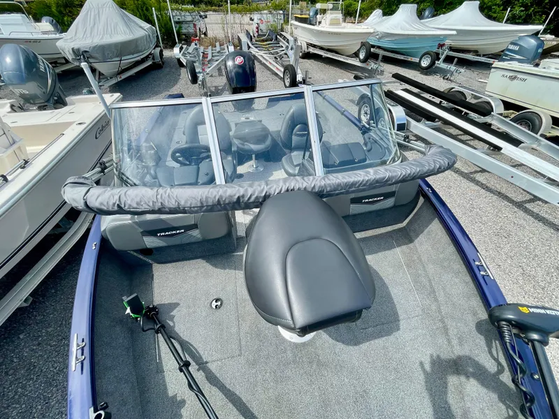 Slide: The Image of 2020 Tracker Pro Guide V-175 Combo boat in a marina, surrounded by other boats. - 8
