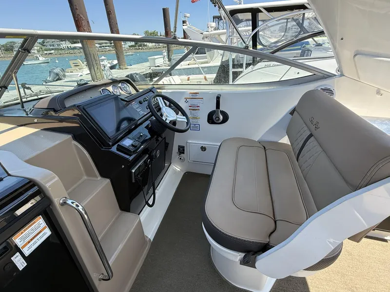 Slide: The Image of 2017 Sea Ray Sundancer 280 helm with beige seating and modern controls. - 14