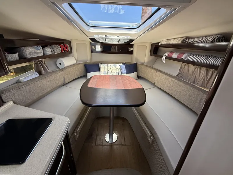 Slide: The Image of Interior of 2017 Sea Ray Sundancer 280, featuring cozy seating and a skylight. - 15