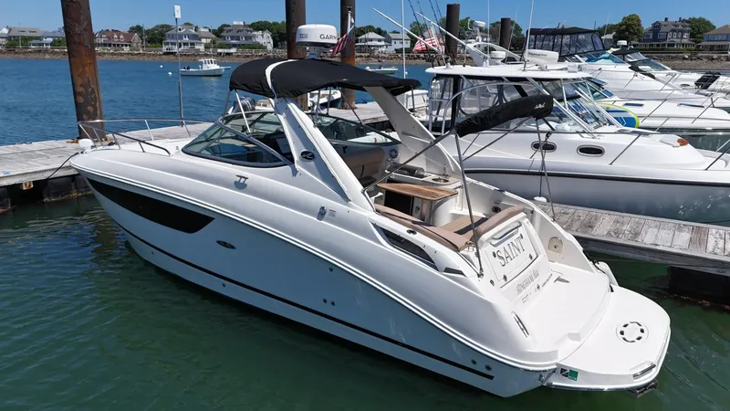 Slide: The Image of 2017 Sea Ray Sundancer 280 docked at marina, featuring sleek design and spacious deck. - 2