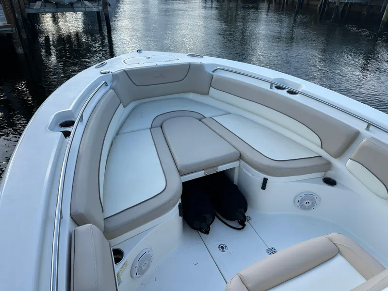 Slide: The Image of 2017 NauticStar 2602 Legacy boat interior with cushioned seating and cup holders. - 12