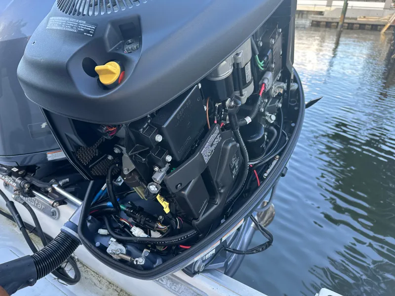 Slide: The Image of Open engine of a 2017 NauticStar 2602 Legacy boat, docked by the water. - 14