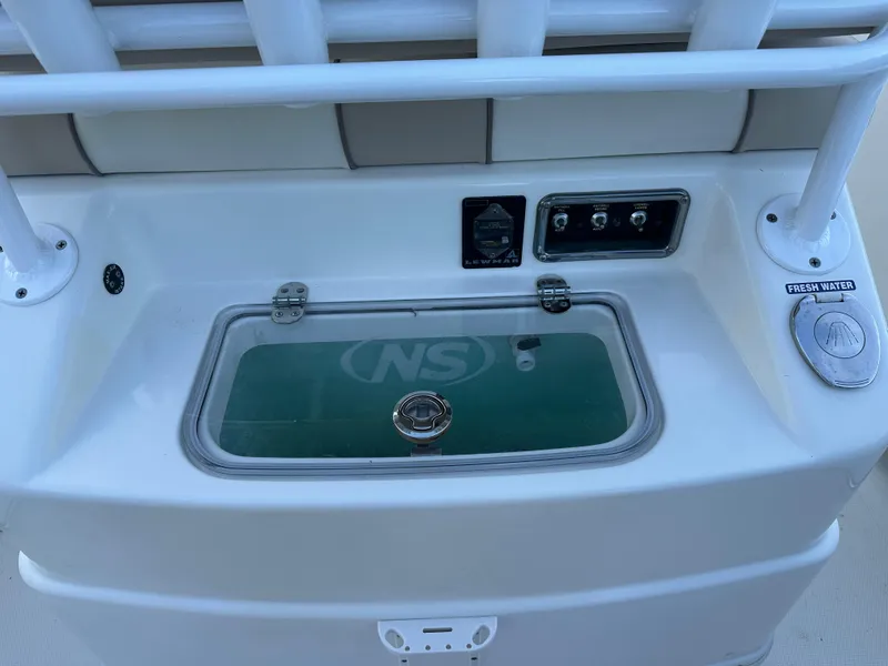 Slide: The Image of 2017 NauticStar 2602 Legacy boat console with controls and fresh water access. - 5