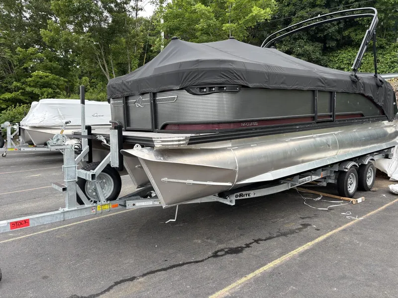 The Image of 2023 Qwest Lanai 822 pontoon boat on trailer, covered, in outdoor setting. - 0