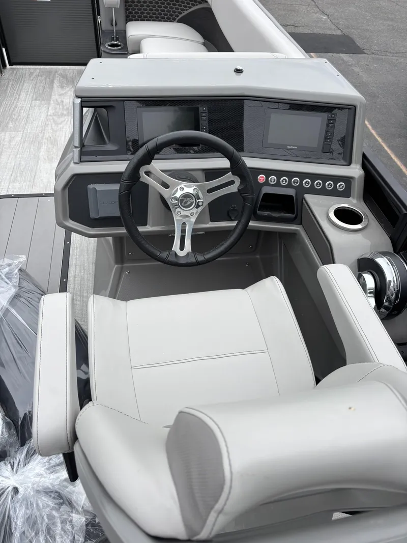 Slide: The Image of Captain's chair and helm of 2023 Qwest Lanai 822 pontoon boat, featuring modern controls. - 2