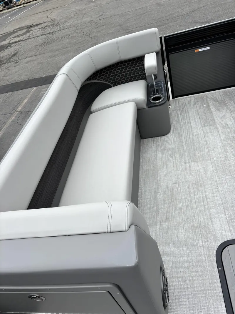 Slide: The Image of 2023 Qwest Lanai 822 boat interior with gray seating and cup holder. - 3