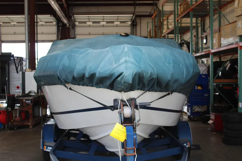 Slide: The Image of Covered 1994 Celebrity 230 BR boat on trailer in a garage. - 10
