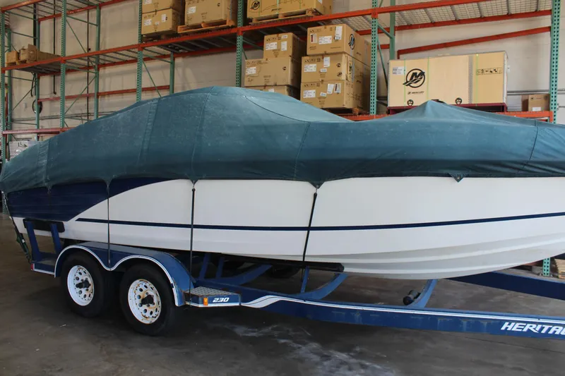 Slide: The Image of Covered 1994 Celebrity 230 BR boat on trailer in warehouse. - 11