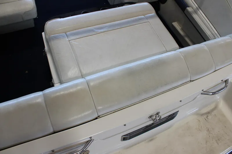 Slide: The Image of White leather seating in a 1994 Celebrity 230 BR boat interior. - 13
