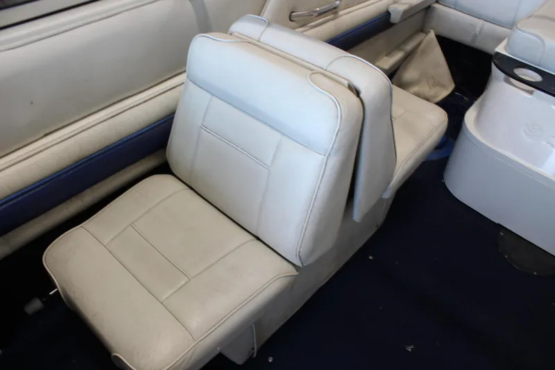 Slide: The Image of White leather seat in a 1994 Celebrity 230 BR boat interior. - 15