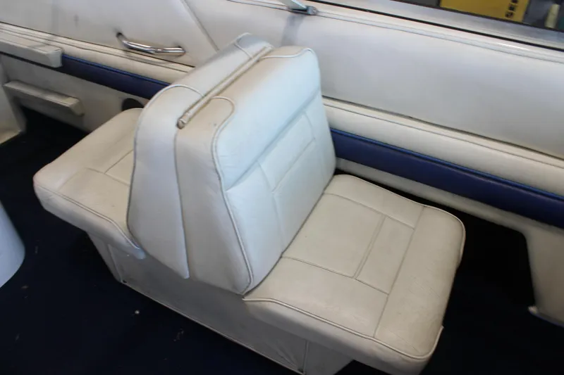 Slide: The Image of White leather seat in a 1994 Celebrity 230 BR boat interior. - 16