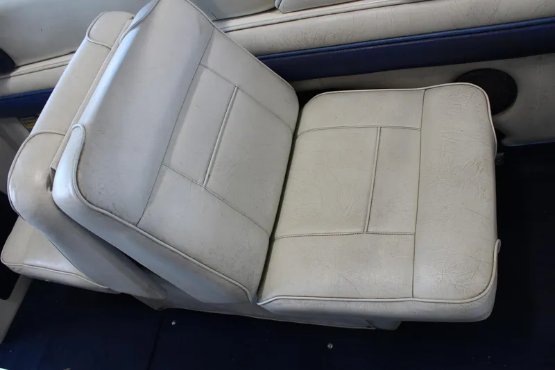 Slide: The Image of White leather seat in a 1994 Celebrity 230 BR boat interior. - 19