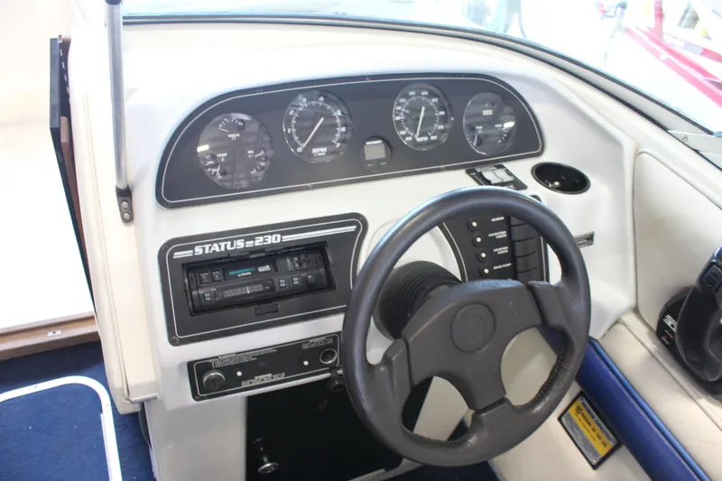 Slide: The Image of Dashboard of a 1994 Celebrity 230 BR boat with steering wheel and instrument panel. - 25