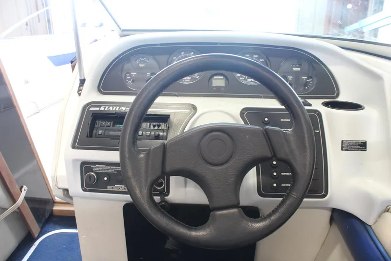 Slide: The Image of Steering wheel and dashboard of a 1994 Celebrity 230 BR boat. - 26