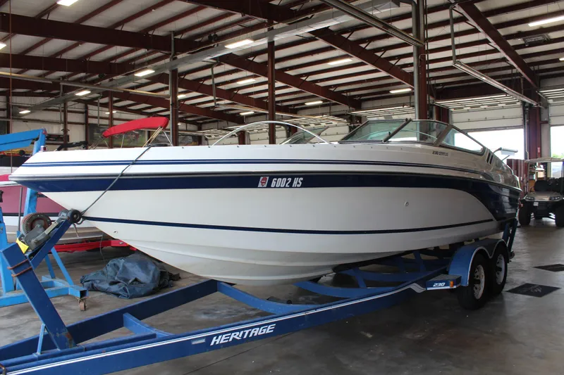 Slide: The Image of 1994 Celebrity 230 BR boat on trailer in indoor storage facility. - 3