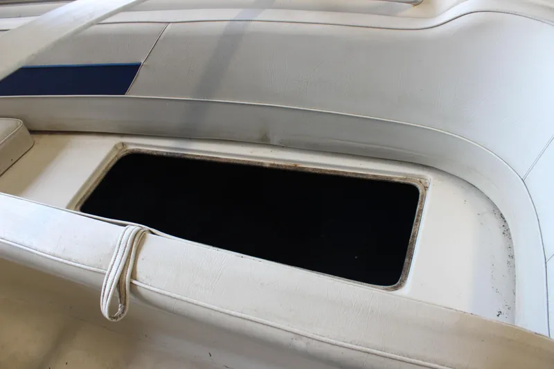 Slide: The Image of Open storage compartment on a 1994 Celebrity 230 BR boat with white interior. - 31