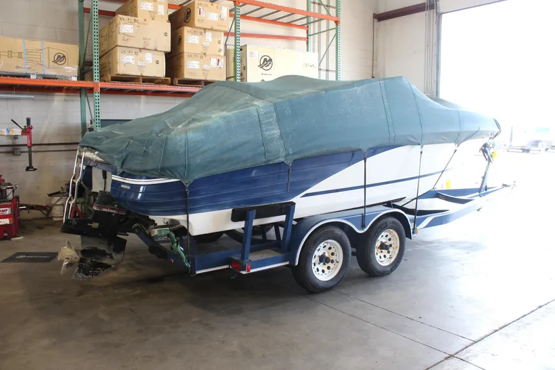 Slide: The Image of Covered 1994 Celebrity 230 BR boat on trailer in warehouse. - 6
