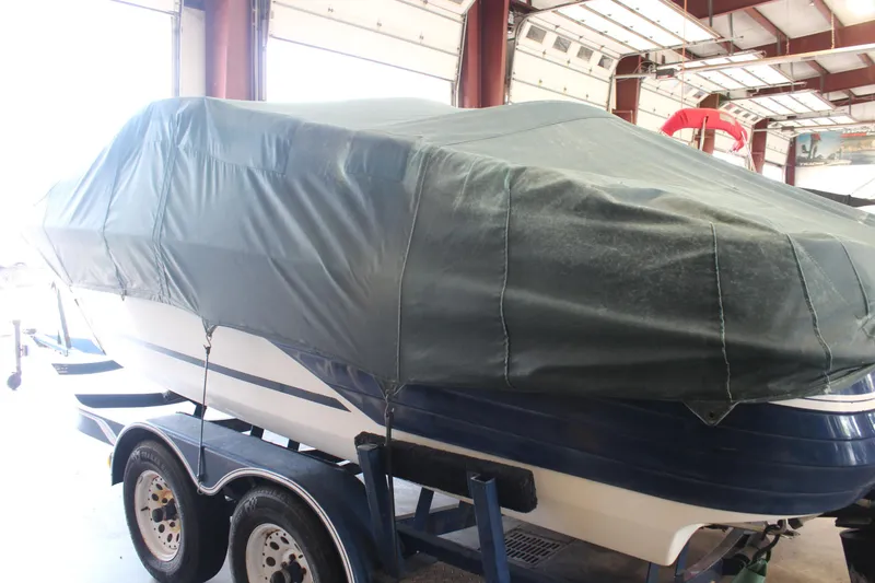 Slide: The Image of Covered 1994 Celebrity 230 BR boat on trailer in indoor storage facility. - 8