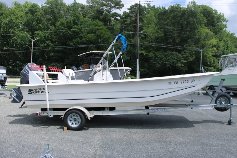 Slide: The Image of 2010 Carolina Skiff 2180 DLX boat on trailer, parked outdoors. - 10