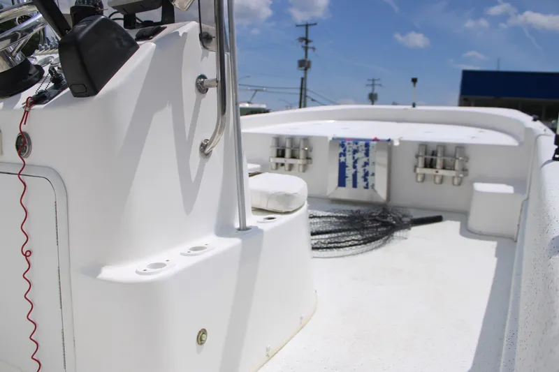 Slide: The Image of 2010 Carolina Skiff 2180 DLX boat interior with fishing gear and console. - 12