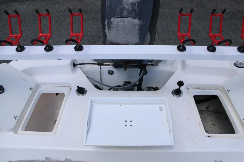 Slide: The Image of 2010 Carolina Skiff 2180 DLX boat deck with rod holders and storage compartments. - 15