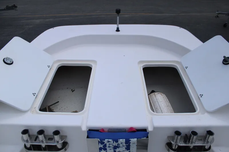 Slide: The Image of 2010 Carolina Skiff 2180 DLX boat storage compartments and rod holders. - 17
