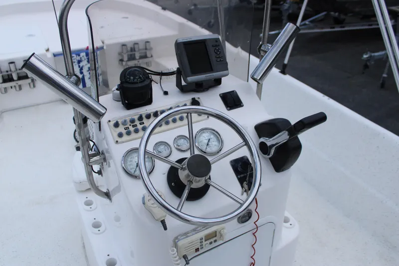 Slide: The Image of 2010 Carolina Skiff 2180 DLX boat console with steering wheel and navigation instruments. - 18