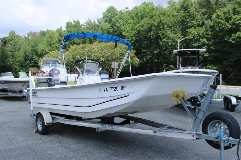 Slide: The Image of 2010 Carolina Skiff 2180 DLX boat on trailer, parked outdoors. - 3