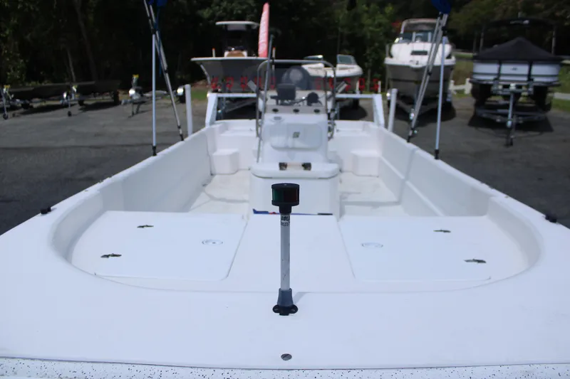 Slide: The Image of 2010 Carolina Skiff 2180 DLX boat, white interior, parked outdoors. - 4