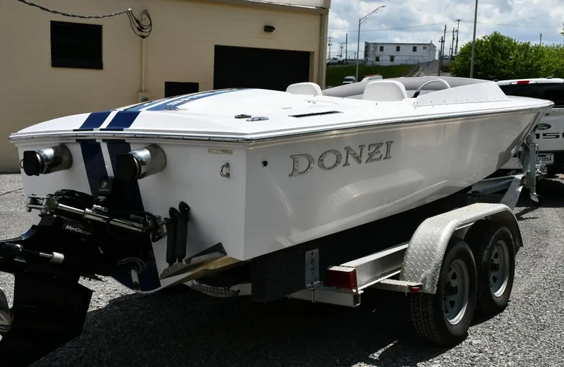 Slide: The Image of 2007 Donzi Carol Shelby 22 Classic boat on trailer, white with blue stripes. - 12