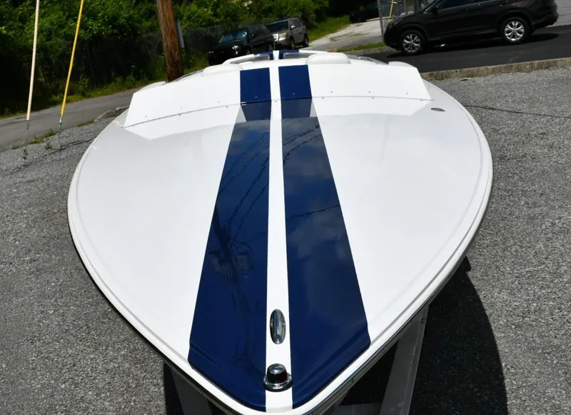 Slide: The Image of 2007 Donzi Carol Shelby 22 Classic boat with blue racing stripes on a trailer. - 3