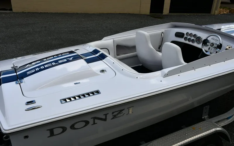 Slide: The Image of 2007 Donzi Carol Shelby 22 Classic boat with white interior and blue racing stripes. - 4