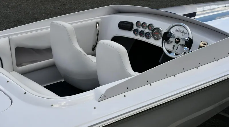 Slide: The Image of 2007 Donzi Carol Shelby 22 Classic boat interior with white seats and dashboard gauges. - 5
