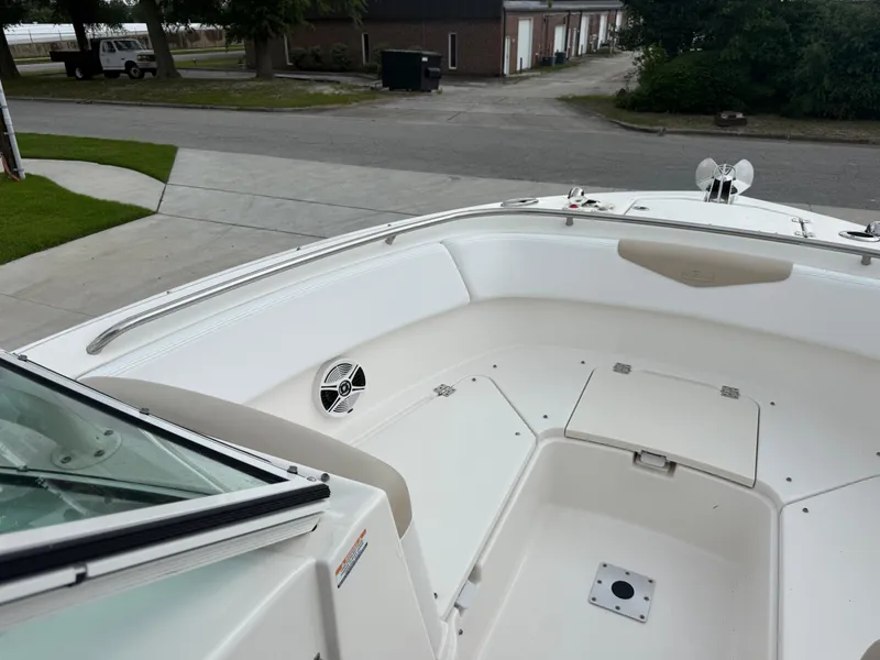 Slide: The Image of 2018 Robalo R247 Dual Console boat interior with seating and storage compartments. - 10
