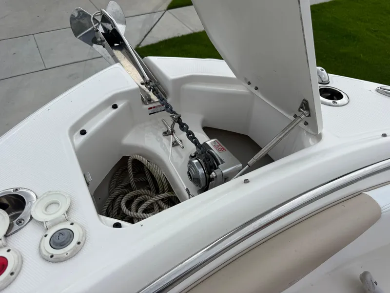 Slide: The Image of 2018 Robalo R247 Dual Console anchor compartment with rope and winch system. - 11