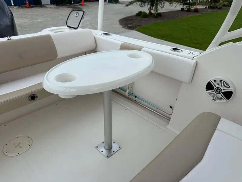 Slide: The Image of 2018 Robalo R247 Dual Console boat interior with table and seating area. - 15