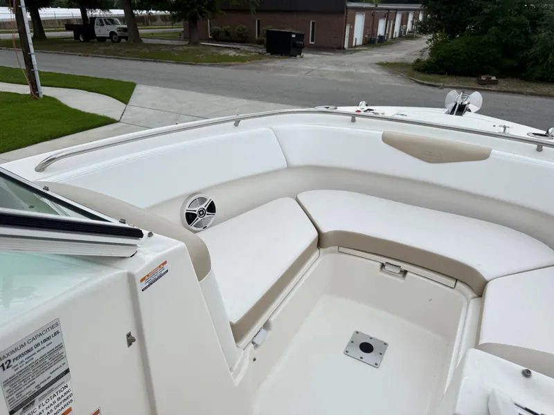 Slide: The Image of 2018 Robalo R247 Dual Console boat interior with white seating and speaker. - 20