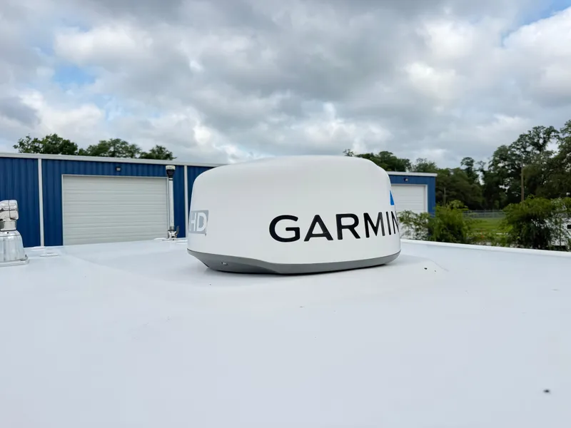 Slide: The Image of Garmin radar on 2018 Robalo R247 Dual Console boat under cloudy sky. - 22