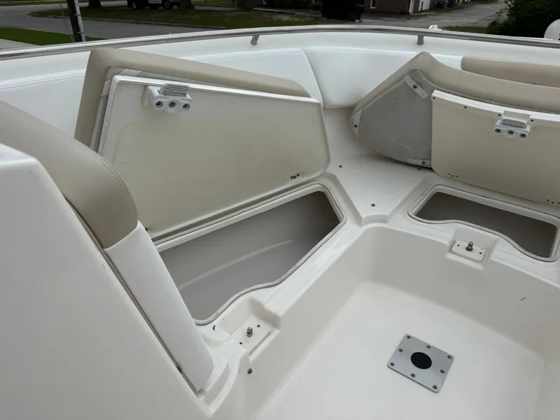 Slide: The Image of 2018 Robalo R247 Dual Console boat interior with open storage compartments. - 23