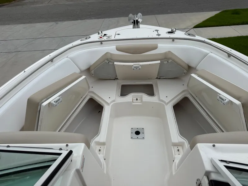 Slide: The Image of 2018 Robalo R247 Dual Console boat interior with open storage compartments. - 25