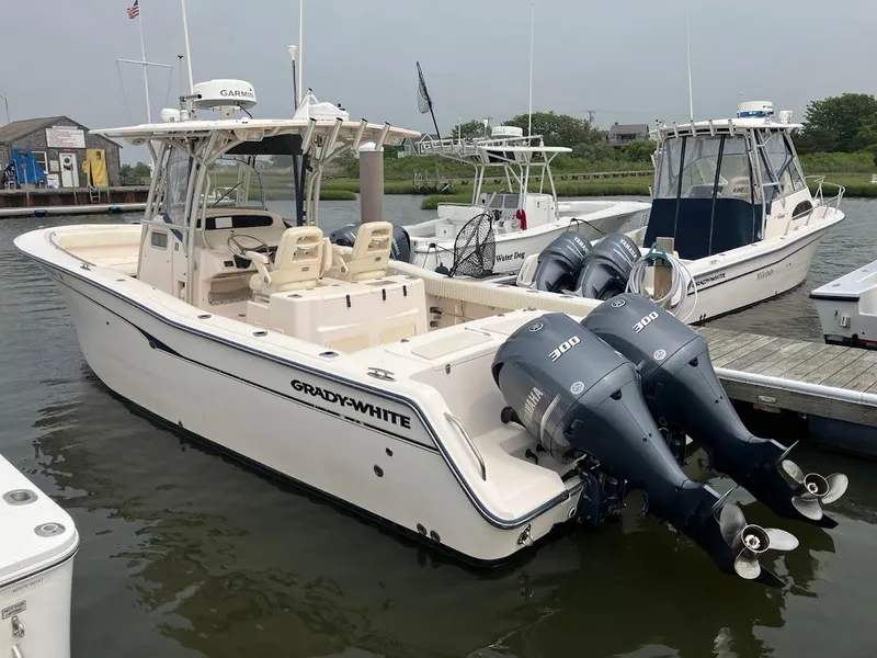 Slide: The Image of 2006 Grady-White Bimini 306 boat docked with twin Yamaha engines. - 1