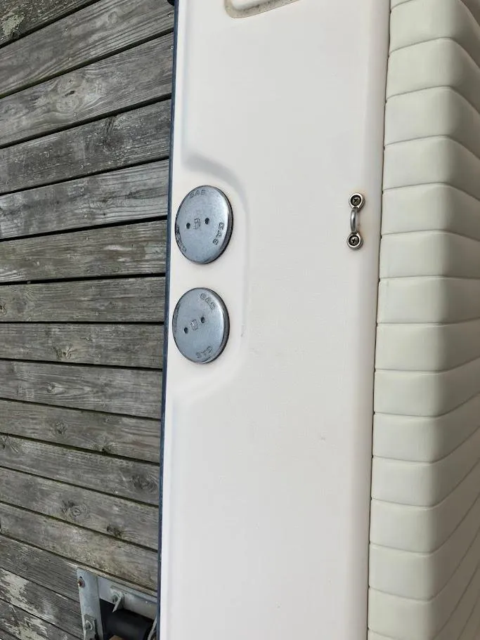 Slide: The Image of 2006 Grady-White Bimini 306 boat detail with wooden dock background. - 10