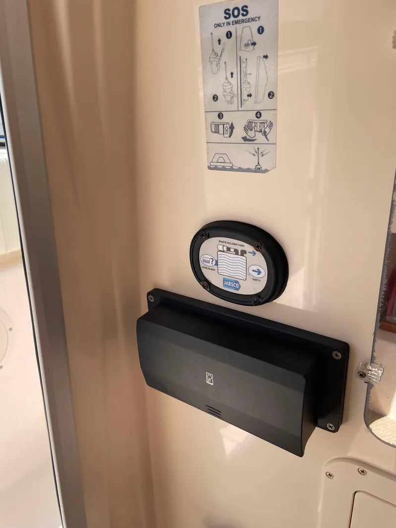 Slide: The Image of Control panel and SOS instructions on 2006 Grady-White Bimini 306 boat interior. - 12