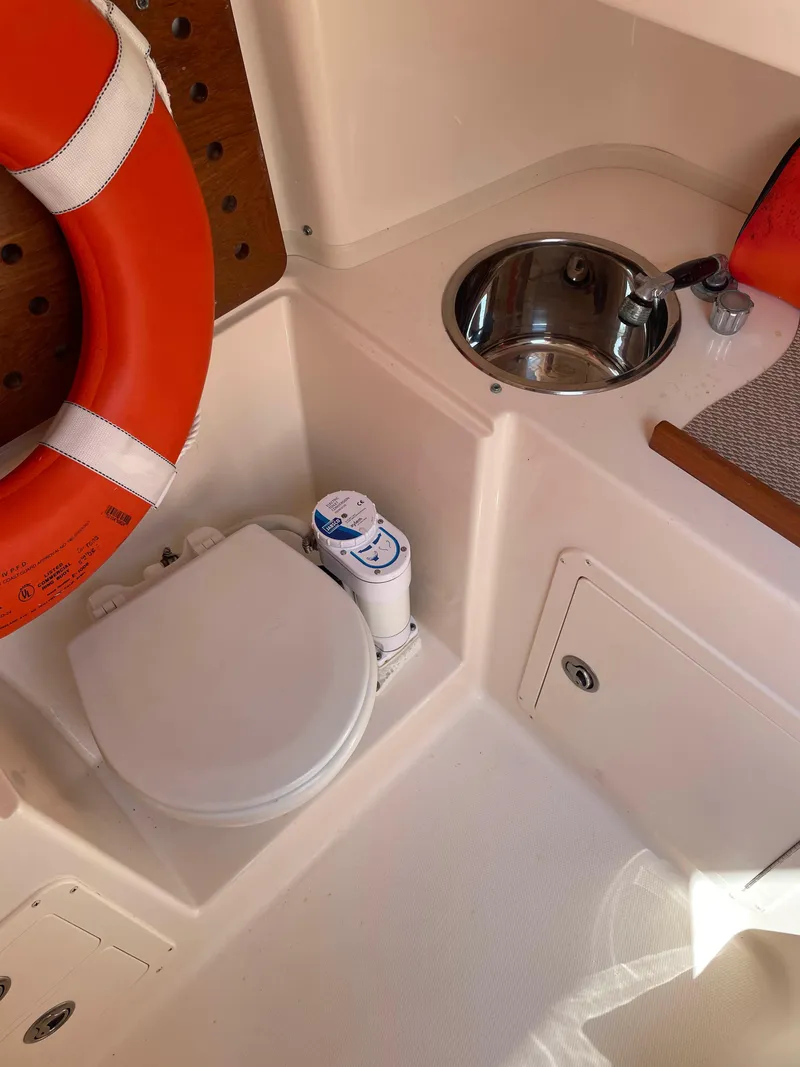 Slide: The Image of 2006 Grady-White Bimini 306 boat interior with sink, toilet, and life preserver. - 15