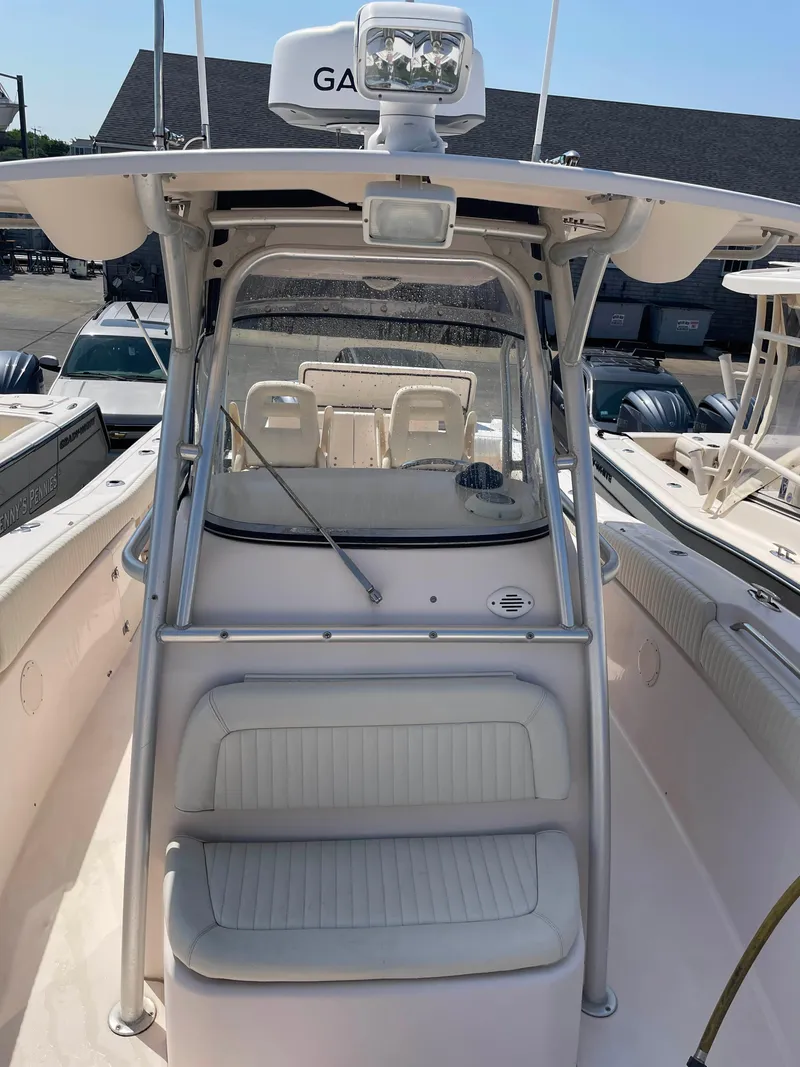 Slide: The Image of 2006 Grady-White Bimini 306 boat interior with seating and navigation equipment. - 17